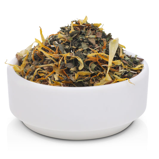 Glow & Tell detox and skin radiance tea blend with herbal ingredients for gut health support, presented in premium A clean white bowl.